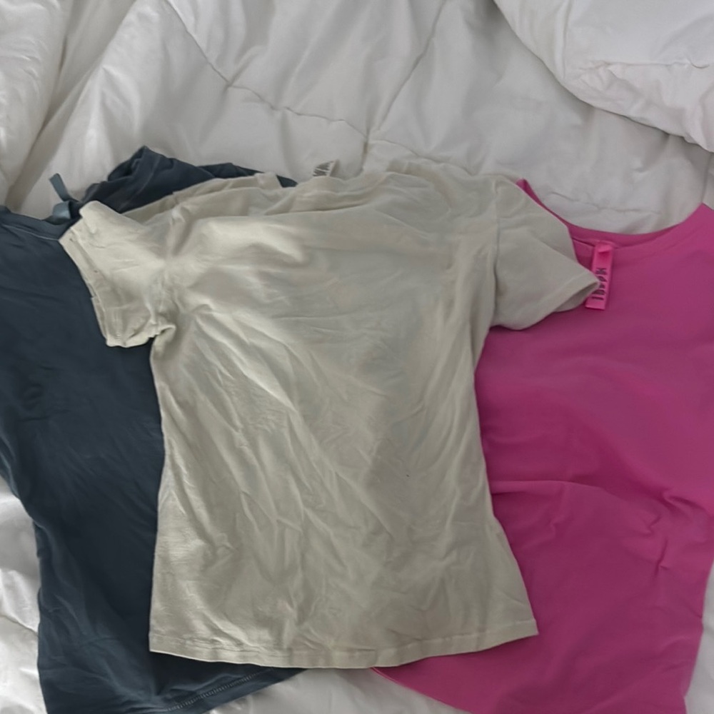 SKIMS Trio T-Shirt Set in Pink, Cream, and blue green